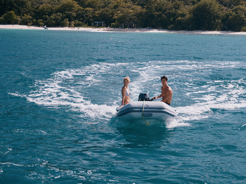 Man and women on a boat in the ocean.