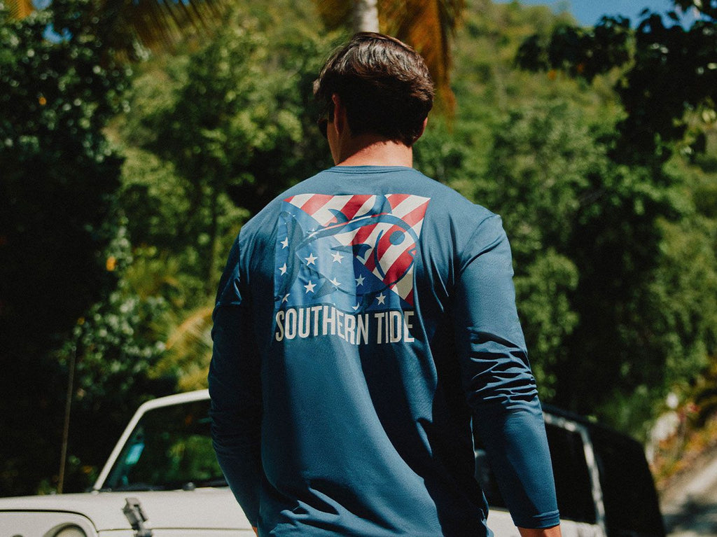 Man walking wearing a patriotic flag t-shirt.