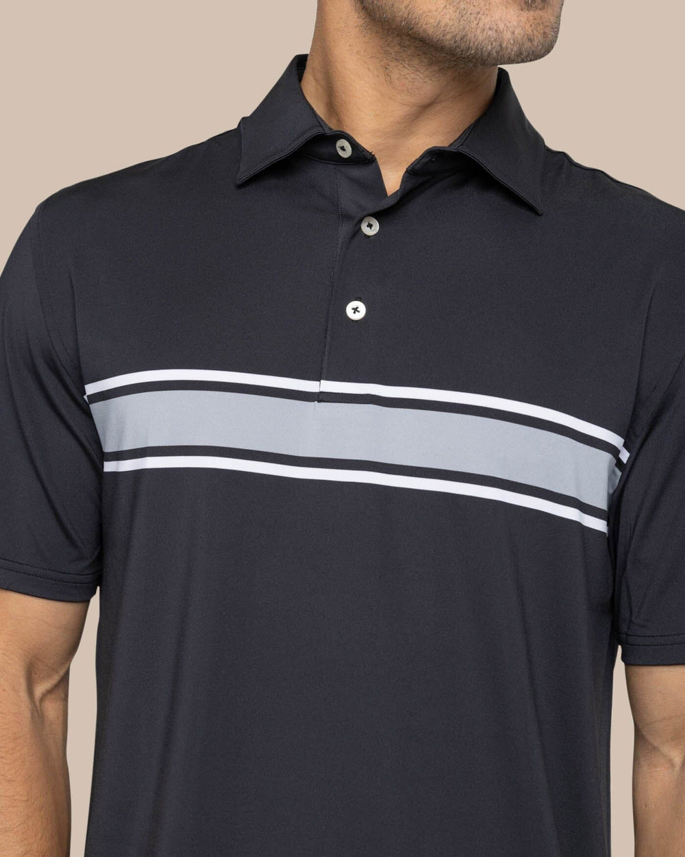 The detail view of the Southern Tide Brenton Chest Stripe Performance Polo by Southern Tide - Black