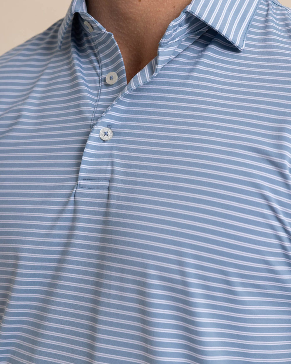 The detail view of the Southern Tide brrr eeze Beattie Stripe Performance Polo by Southern Tide - Windward Blue