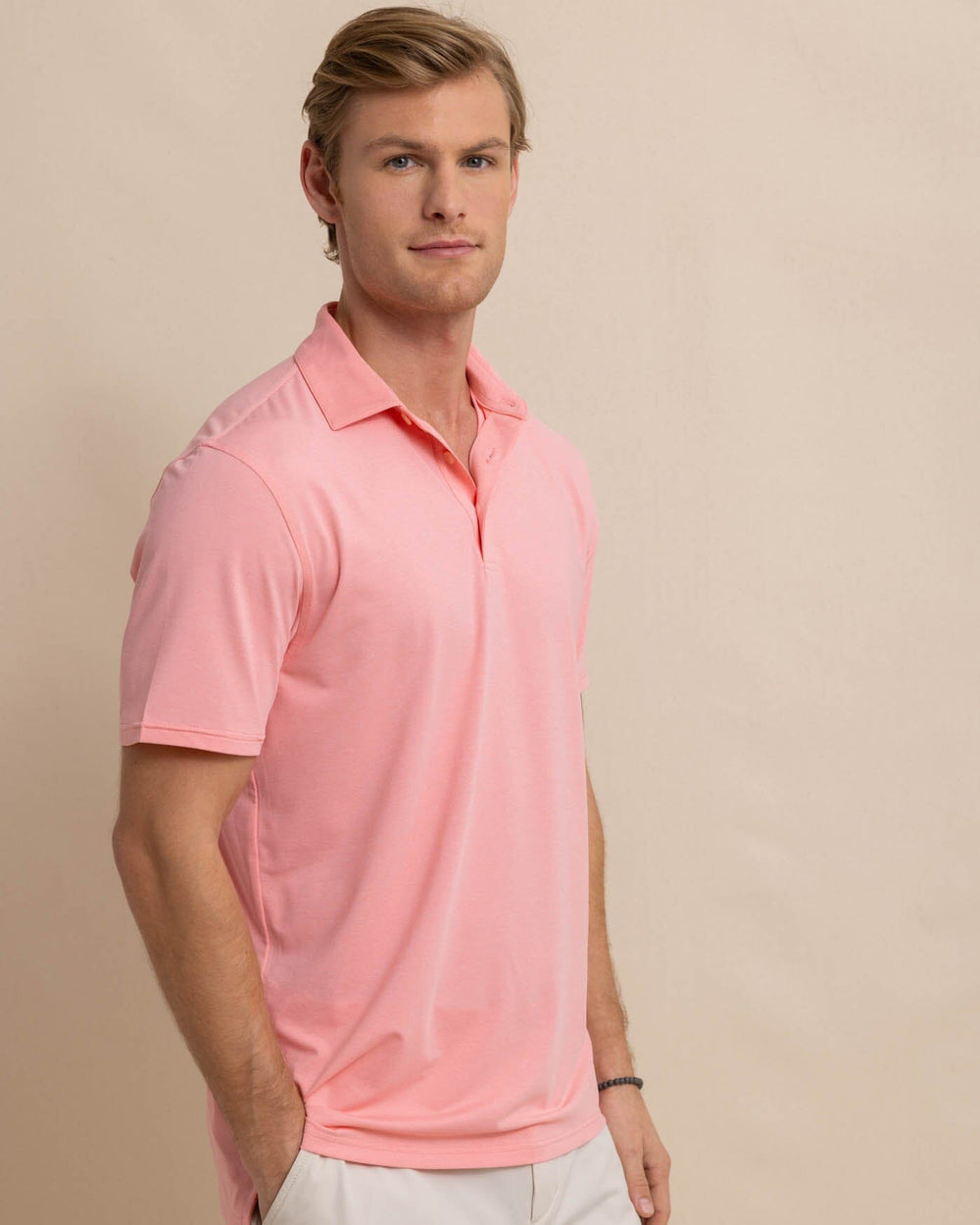 The front view of the Southern Tide brrr-eeze-heather-performance-polo-shirt by Southern Tide - Heather Flamingo Pink