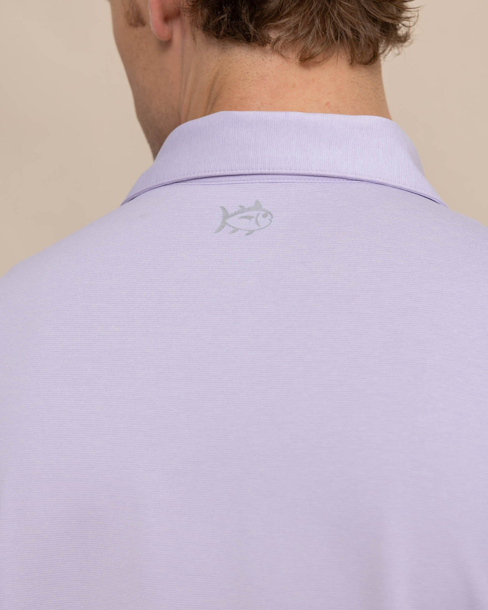 The detail view of the Southern Tide brrr eeze Heather Performance Polo Shirt by Southern Tide - Heather Orchid Petal