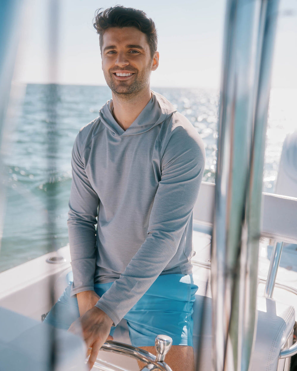 The lifestyle front view of the Southern Tide brrr°®-illiant Performance Hoodie by Southern Tide - Steel Grey