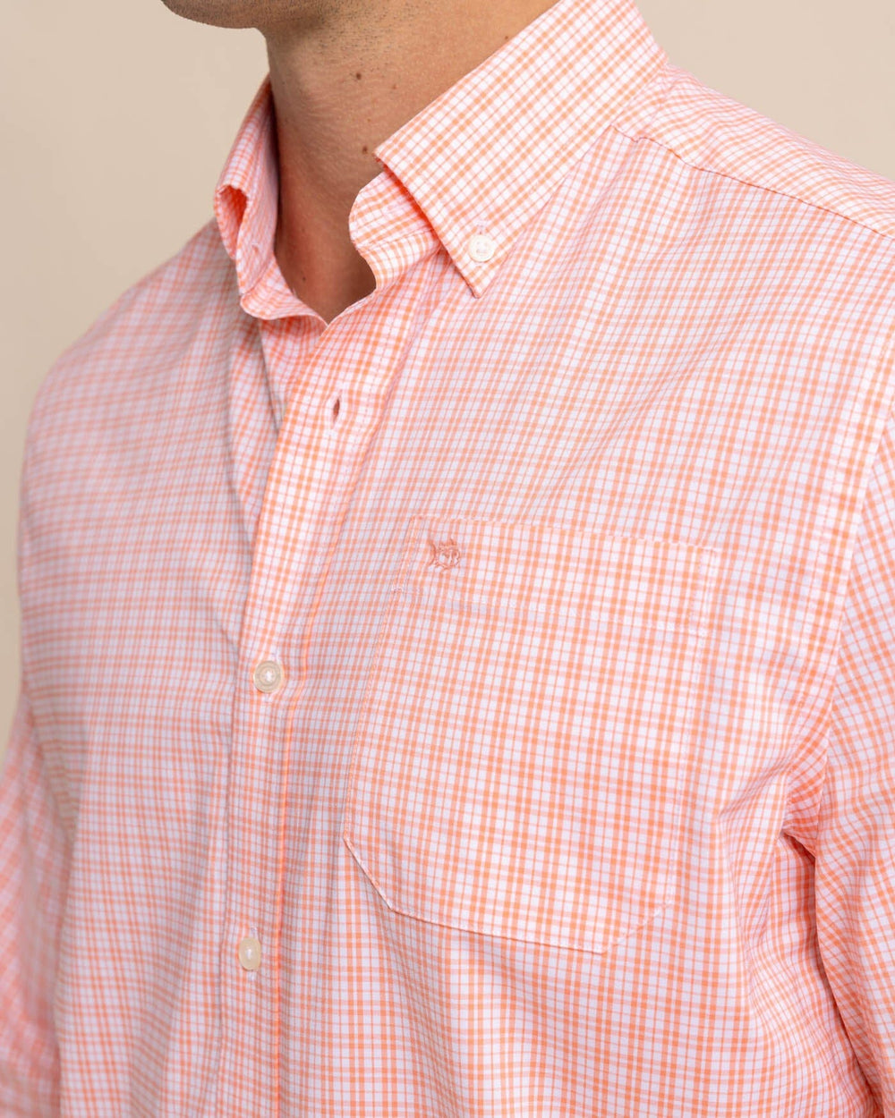 The front view of the Southern Tide brrr Intercoastal Poinsett Plaid Long Sleeve Sport Shirt by Southern Tide - Desert Flower Coral