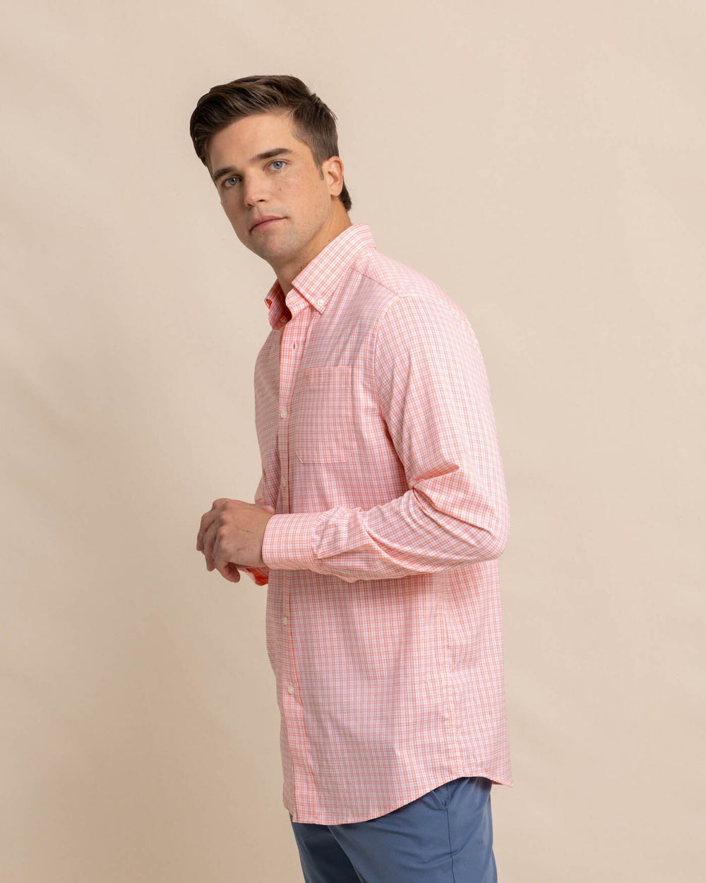 The front view of the Southern Tide brrr Intercoastal Poinsett Plaid Long Sleeve Sport Shirt by Southern Tide - Desert Flower Coral