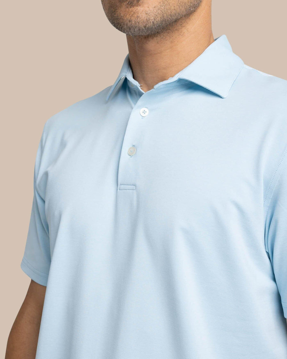 The detail view of the Southern Tide brrr-eeze Heather Performance Polo Shirt by Southern Tide - Heather Dream Blue