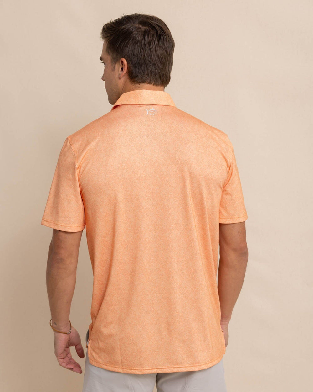 The back view of the Southern Tide Driver Sunny Blooms Polo Shirt by Southern Tide - Tangerine Orange