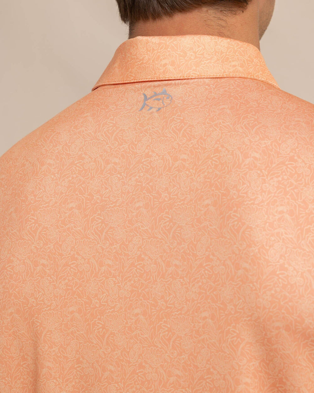 The detail view of the Southern Tide Driver Sunny Blooms Polo Shirt by Southern Tide - Tangerine Orange