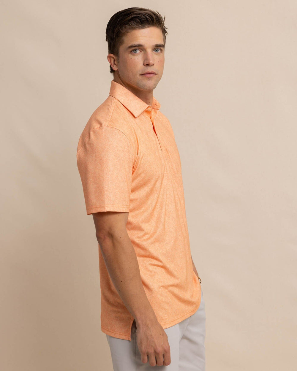 The front view of the Southern Tide Driver Sunny Blooms Polo Shirt by Southern Tide - Tangerine Orange