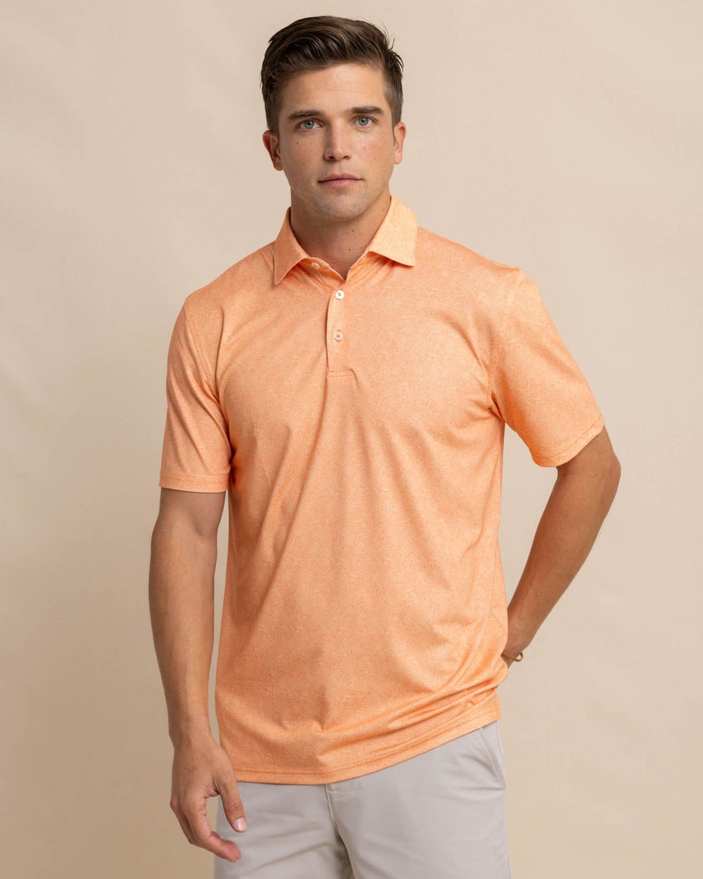 The front view of the Southern Tide Driver Sunny Blooms Polo Shirt by Southern Tide - Tangerine Orange