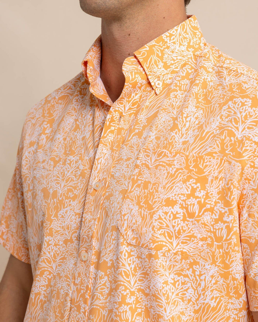 The front view of the Southern Tide Floral Coral Intercoastal Short Sleeve Sport Shirt by Southern Tide - Tangerine Orange