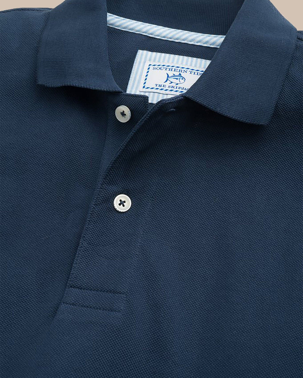 The detail view of the Men's Orange Skipjack Gameday Colors Polo Shirt by Southern Tide - Navy