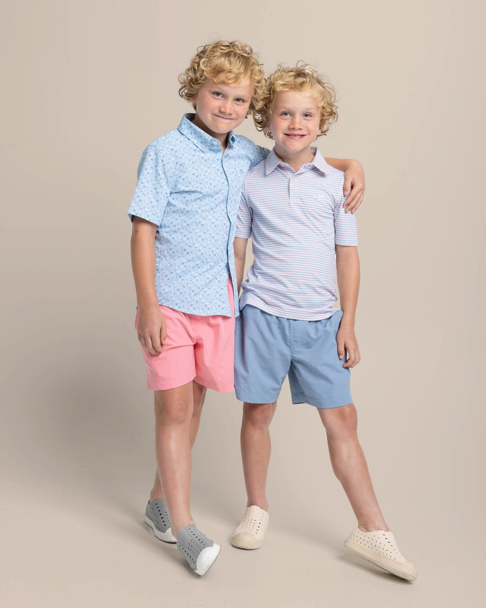 The front view of the Southern Tide Kids Ryder Heather Halls Stripe Performance Polo by Southern Tide - Heather Pale Rosette Pink