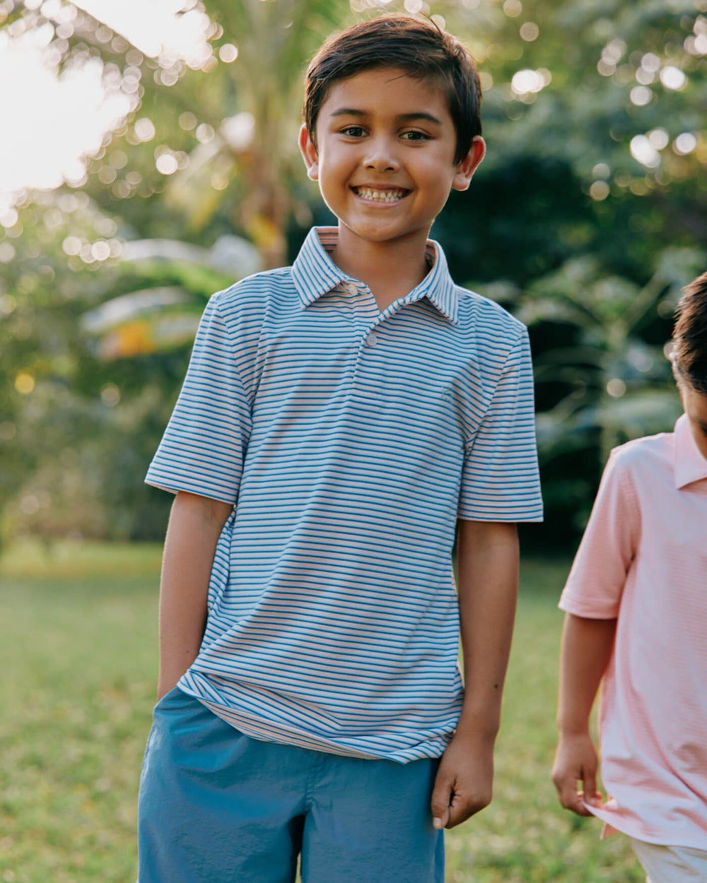 The front view of the Southern Tide Kids Ryder Heather Halls Stripe Performance Polo by Southern Tide - Heather Pale Rosette Pink