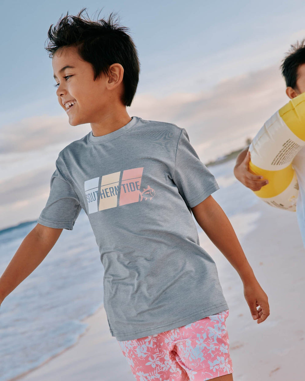 The front view of the Southern Tide Kids ST Tri Block Heather Short Sleeve Performance T-shirt by Southern Tide - Heather Platinum Grey
