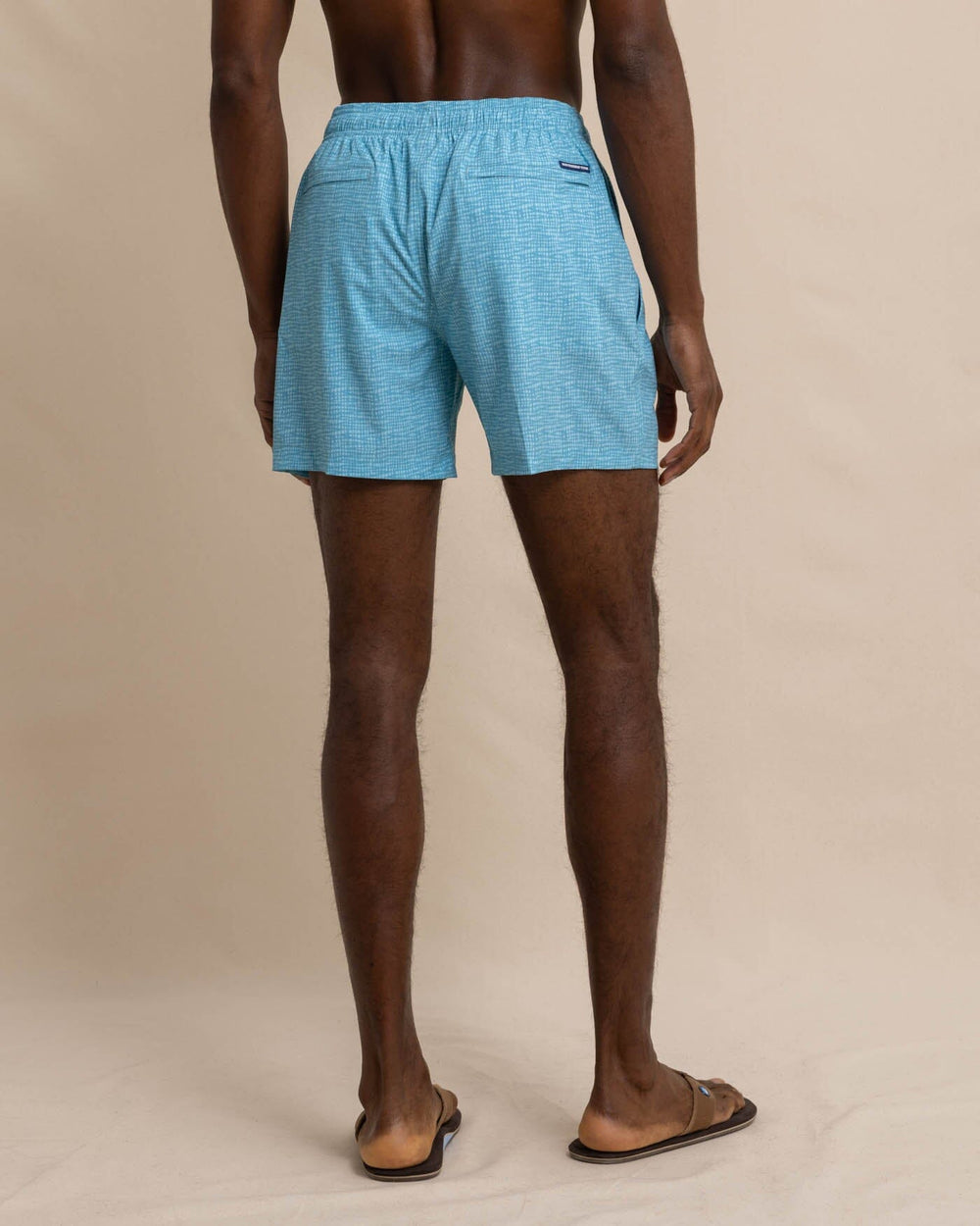 The back view of the Southern Tide Painted Check Swim Trunk by Southern Tide - Wake Blue