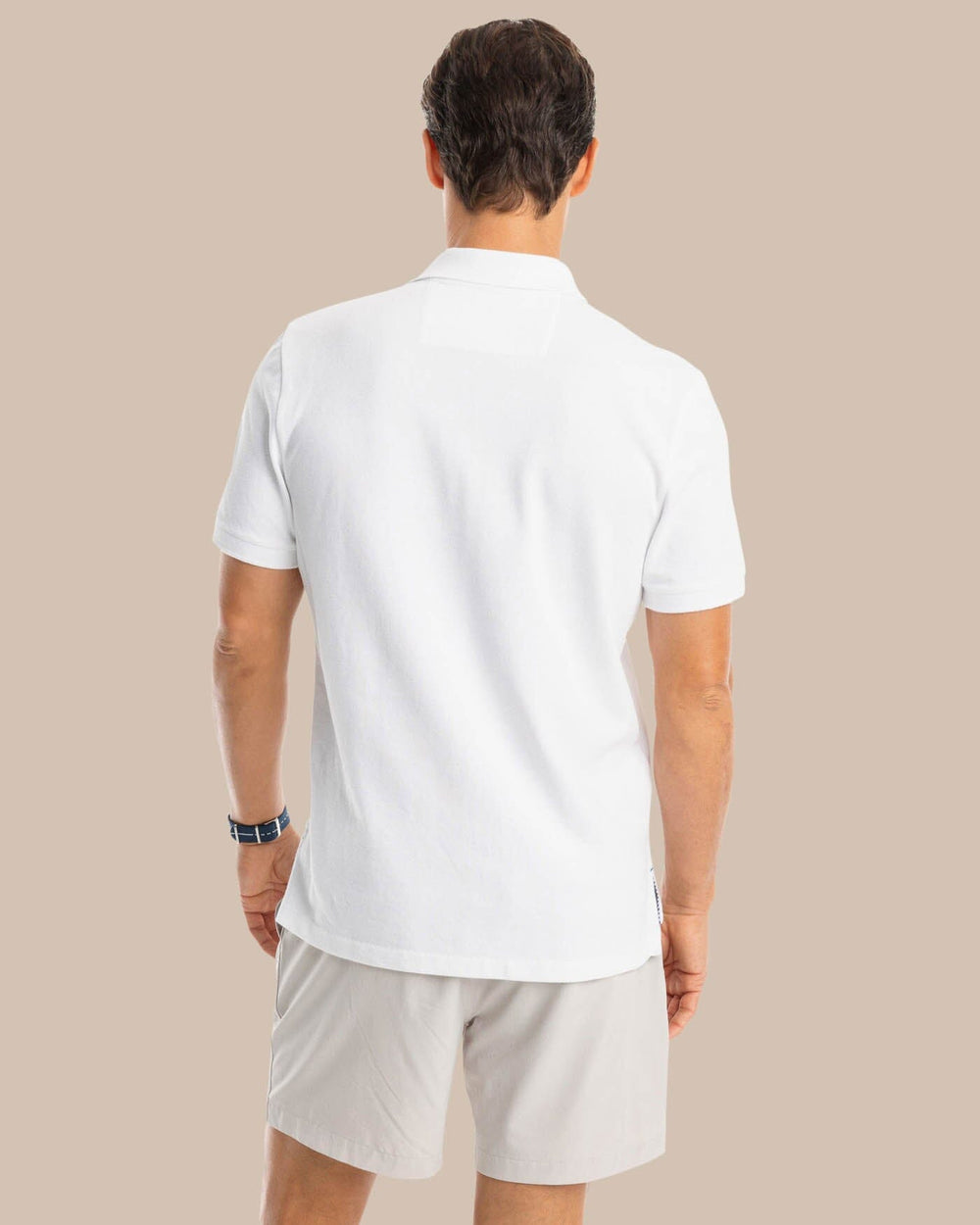 The model back view of the Men's New Skipjack Polo Shirt by Southern Tide - Classic White