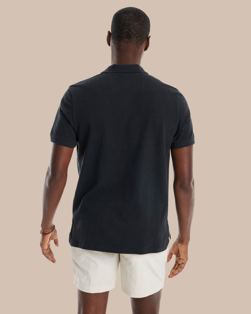 The model back view of the Men's New Skipjack Polo Shirt by Southern Tide - Midnight Black