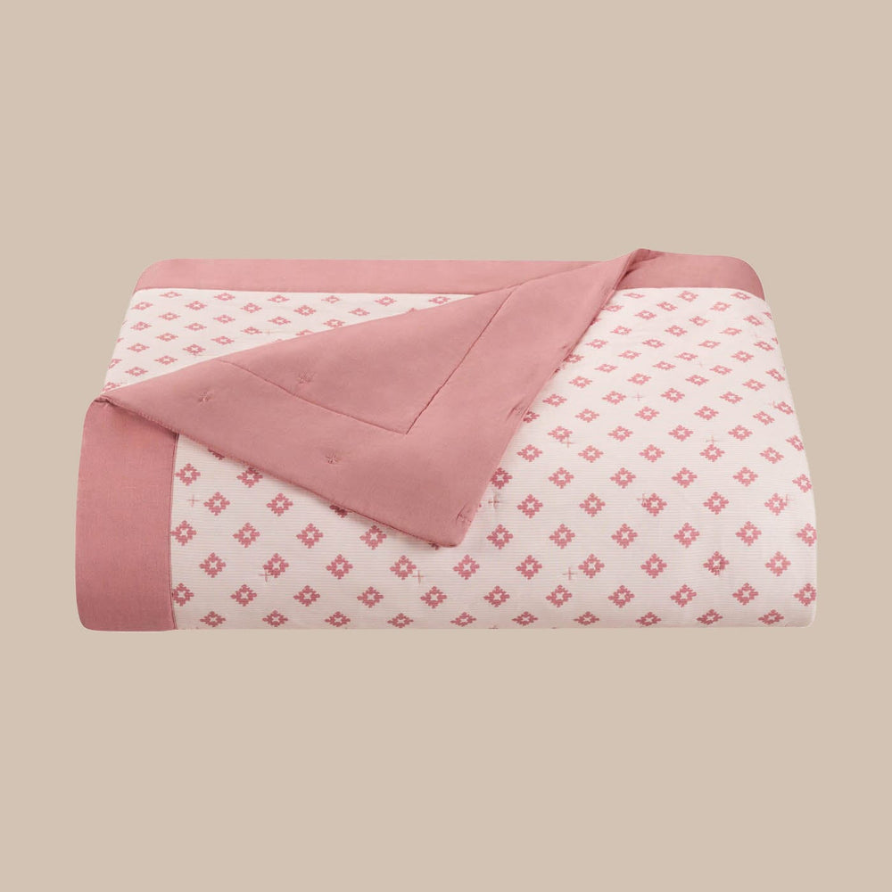 The front view of the Southern Tide Southern Tide Hartsville Coral Quilt by Southern Tide - Coral