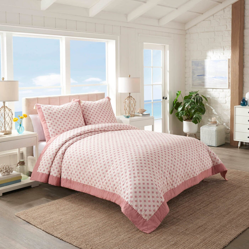 The front view of the Southern Tide Southern Tide Hartsville Coral Quilt by Southern Tide - Coral