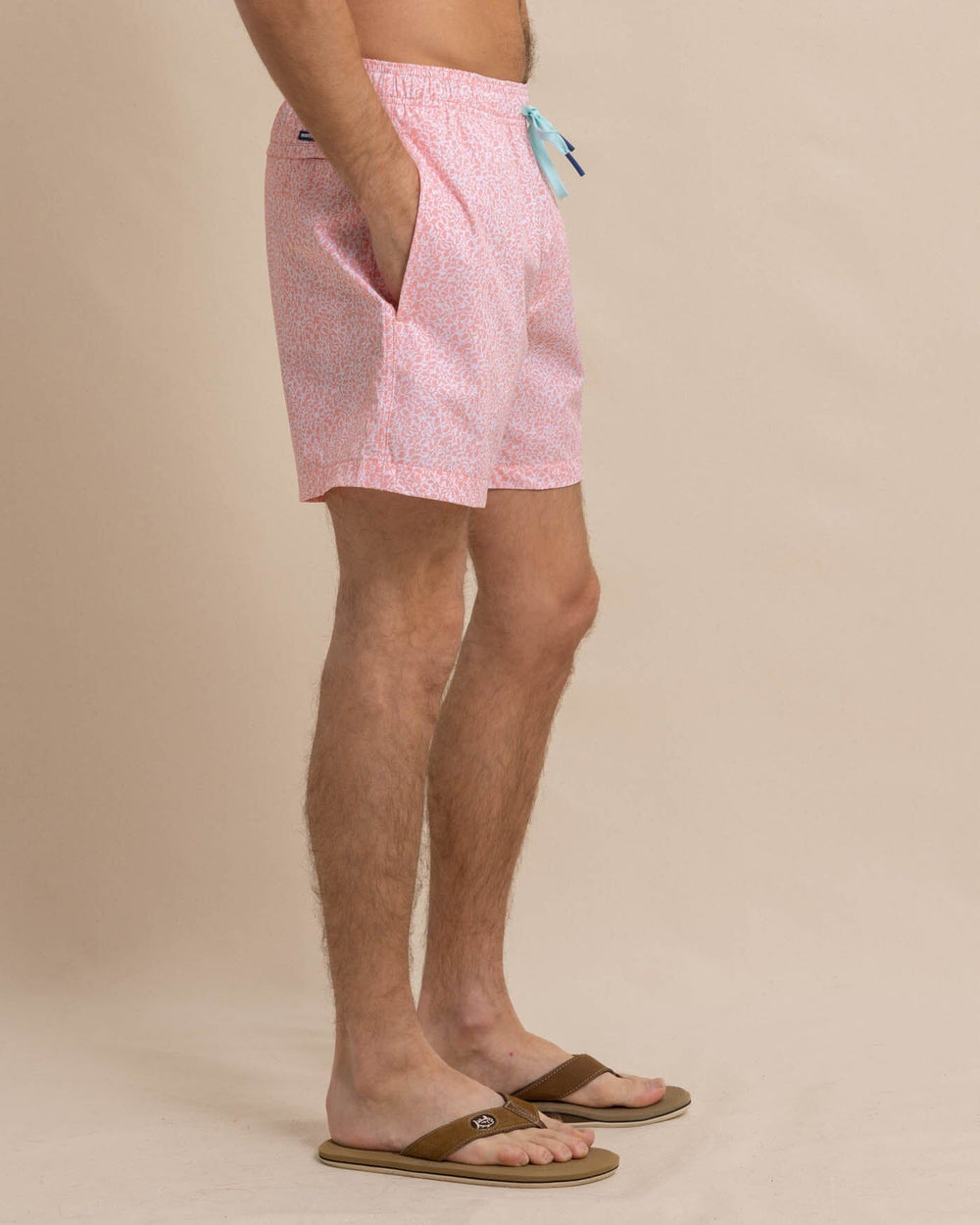 The front view of the Southern Tide That Floral Feeling Swim Trunk by Southern Tide - Apricot Blush Coral